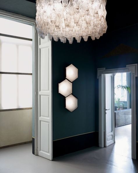 A 1961 oversize Venini chandelier and vintage Stilnovo hexagonal wall lights dominate the entryway. A Fine Balance - T Magazine (nytimes.com)