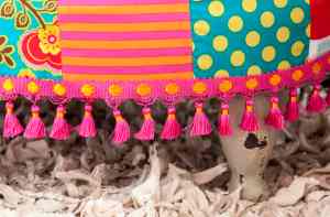 Alternative trims and finishes: You don’t have to limit yourself to upholstery tacks to finish your foot stool off. Pom poms, braiding, ribbon, and even buttons can be glued or stitched around the edge of your foot stool to cover the staples and create a unique trim. You also don’t need to use one whole piece of fabric. A great way of using up remnants of fabric is create a patchwork foot stool. This is a great way to mix up print styles.