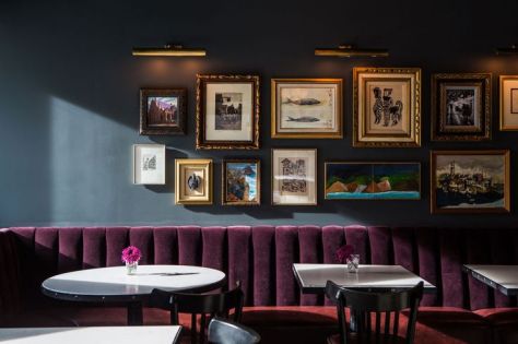 Dark walls and aubergine velvet upholstery, together with a gallery wall work beautifully to create an intimate corner. The Palladian Hotel in Seattle. (lonny.com)